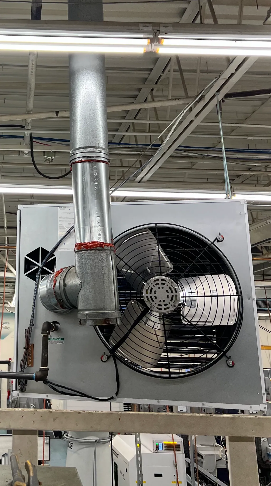 Commercial rooftop heating and ventilation unit in a warehouse facility