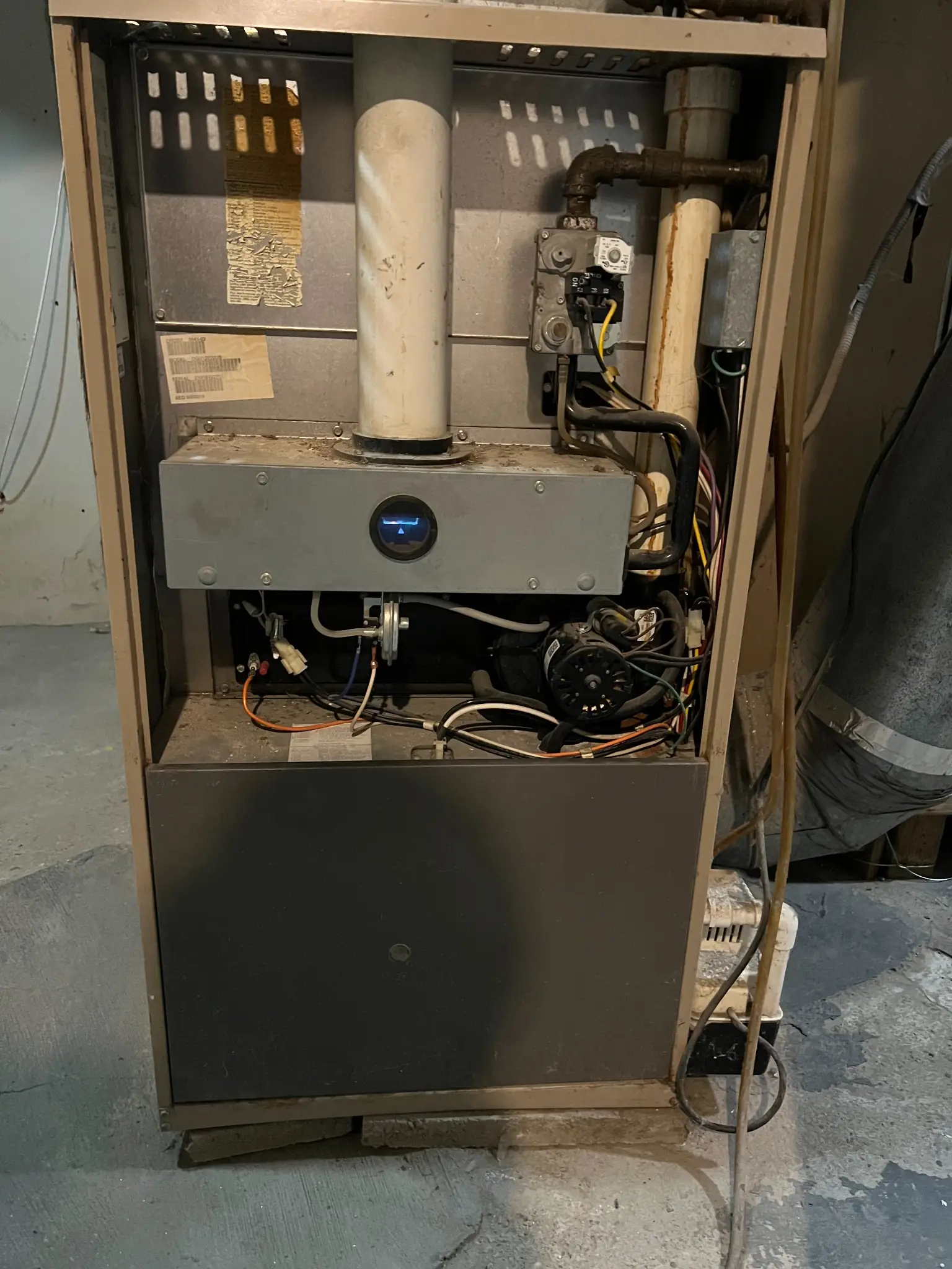Technician servicing the internal components of a gas furnace