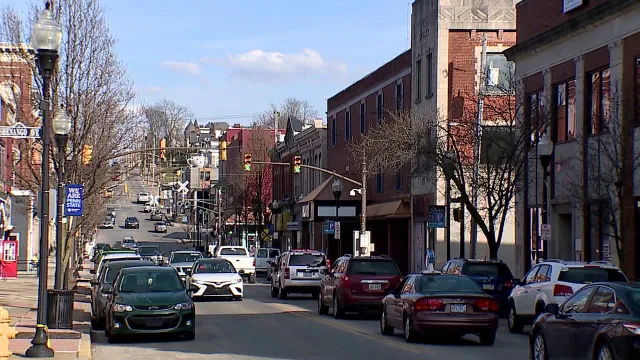 Sharon, MA downtown street lined with shops and parked cars