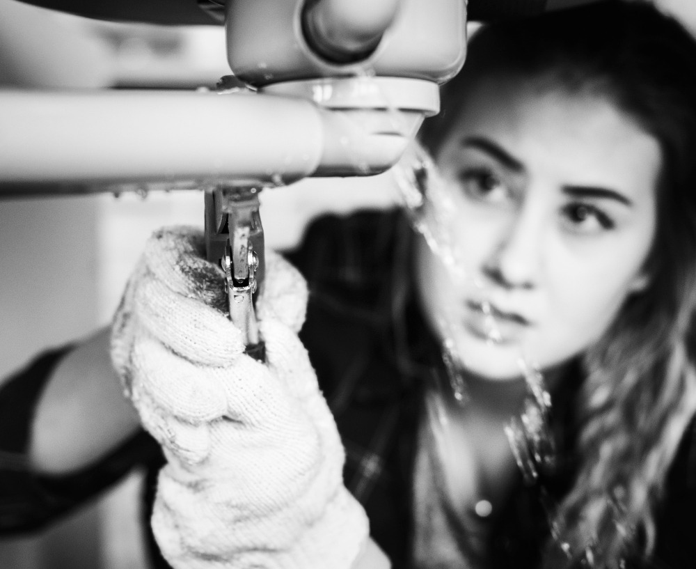 woman-fixing-kitchen-sink